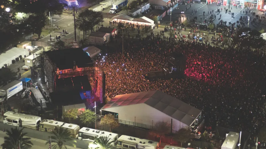 A crowd of people being monitored by a remote drone